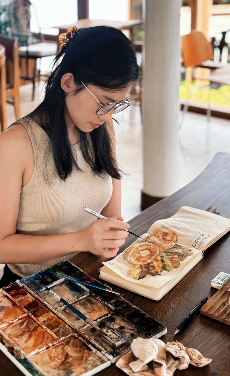 Teepaka painting in her sketchbook